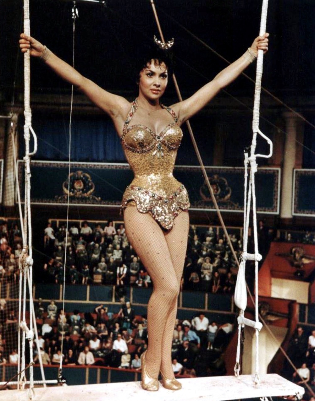 Gina Lollobrigida en costume pailleté doré sur le trapèze du Cirque d'Hiver, film Trapèze